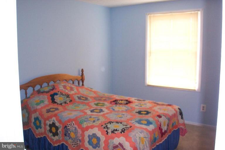 6431 St Phillips Road Linthicum Heights, MD 21090 - Photo 17 of 24 a bedroom with a bed and a window