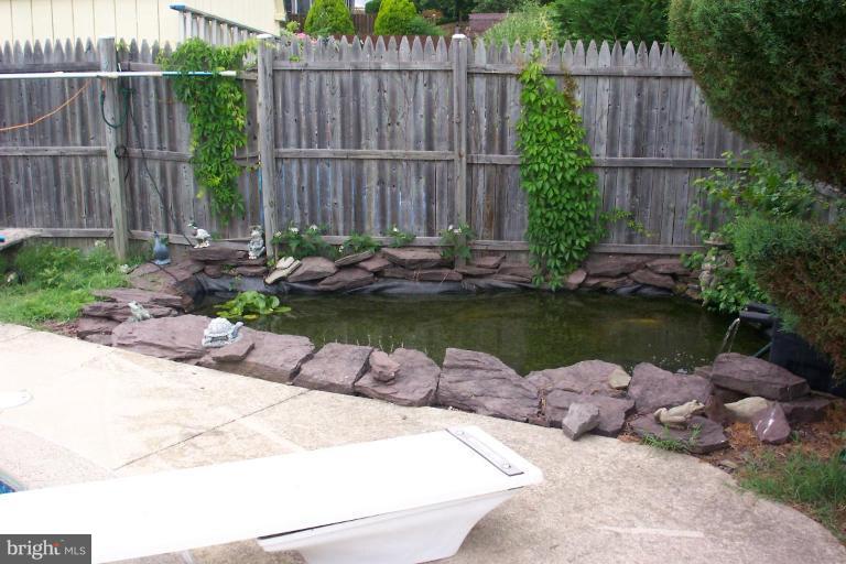 6431 St Phillips Road Linthicum Heights, MD 21090 - Photo 22 of 24 a view of a backyard with plants and outdoor seating