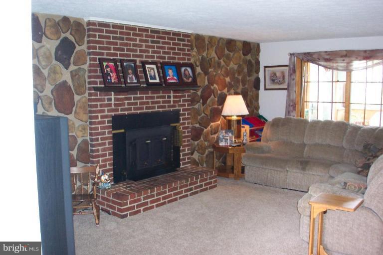 6431 St Phillips Road Linthicum Heights, MD 21090 - Photo 6 of 24 a living room with furniture a window and a fireplace