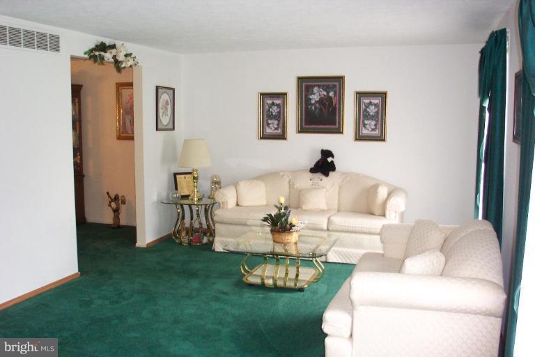 6431 St Phillips Road Linthicum Heights, MD 21090 - Photo 9 of 24 a living room with furniture and a table