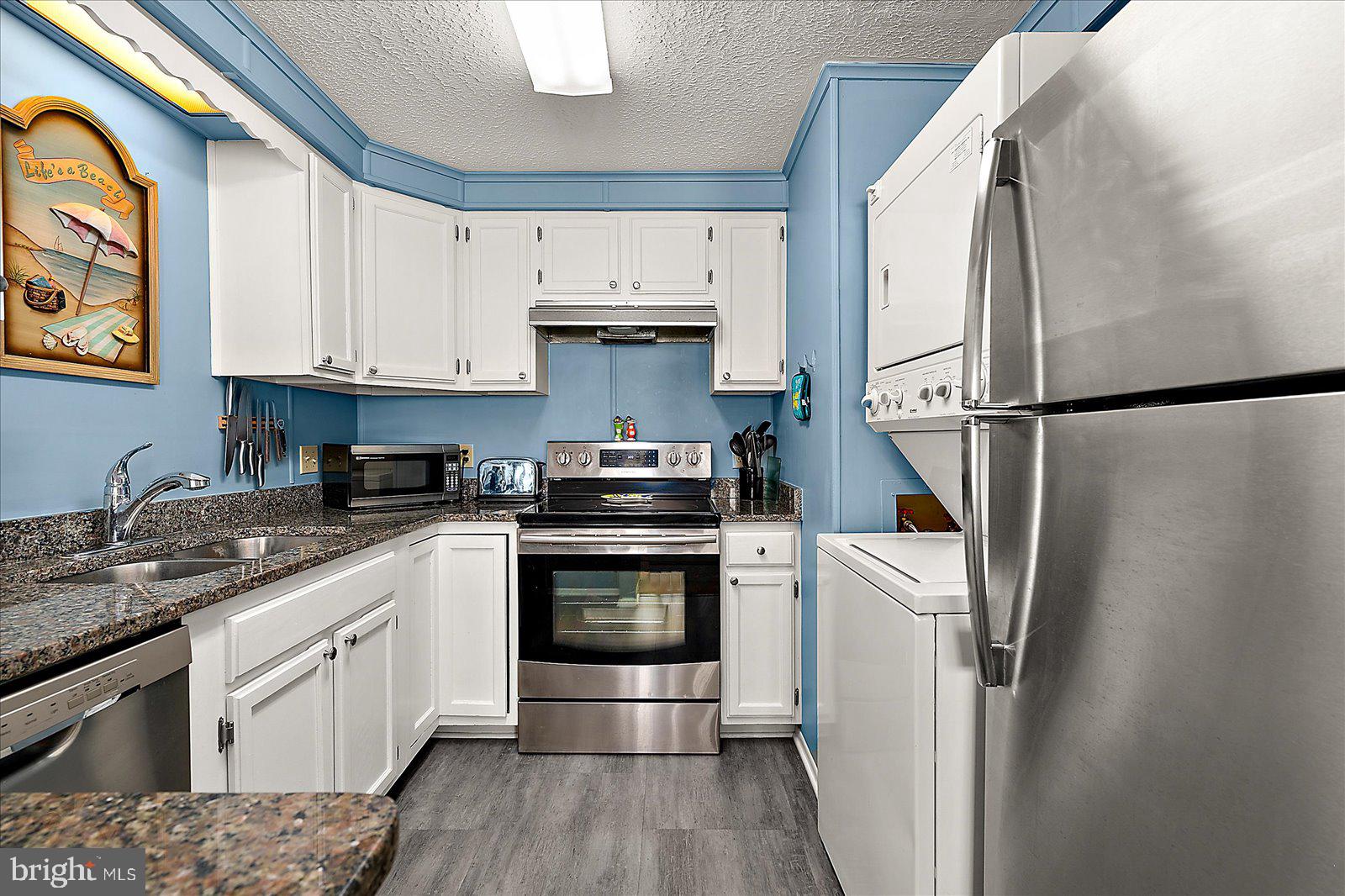 9 46th Street, Unit 22 Ocean City, MD 21842 - Photo 12 of 43 a kitchen with a white cabinets and white appliances