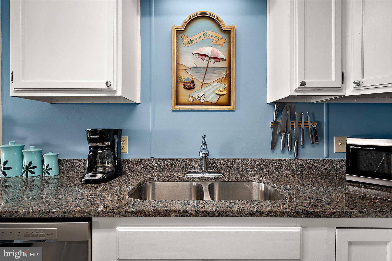 9 46th Street, Unit 22 Ocean City, MD 21842 - Photo 14 of 43 a kitchen with granite countertop a sink a stove and cabinets