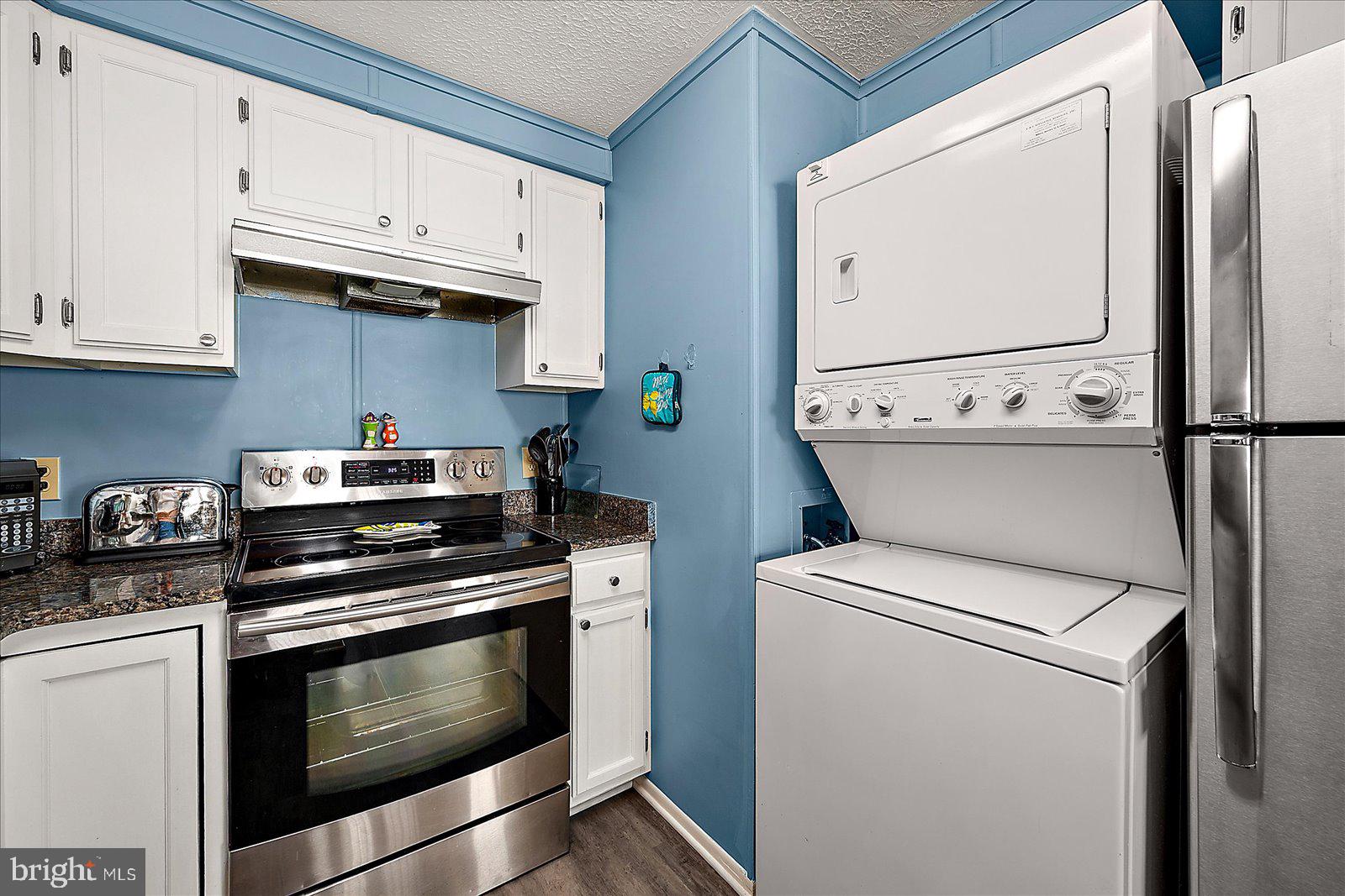 9 46th Street, Unit 22 Ocean City, MD 21842 - Photo 16 of 43 a kitchen with wooden cabinets and a stove top oven