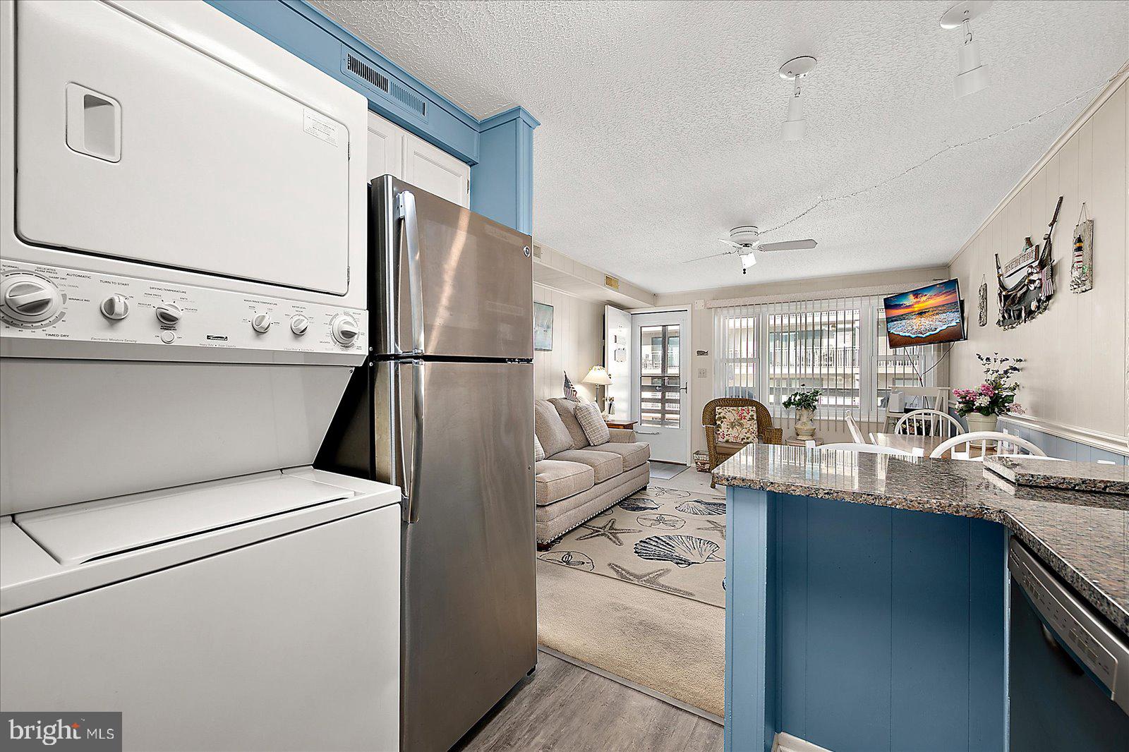 9 46th Street, Unit 22 Ocean City, MD 21842 - Photo 17 of 43 a kitchen with kitchen island a sink appliances and cabinets