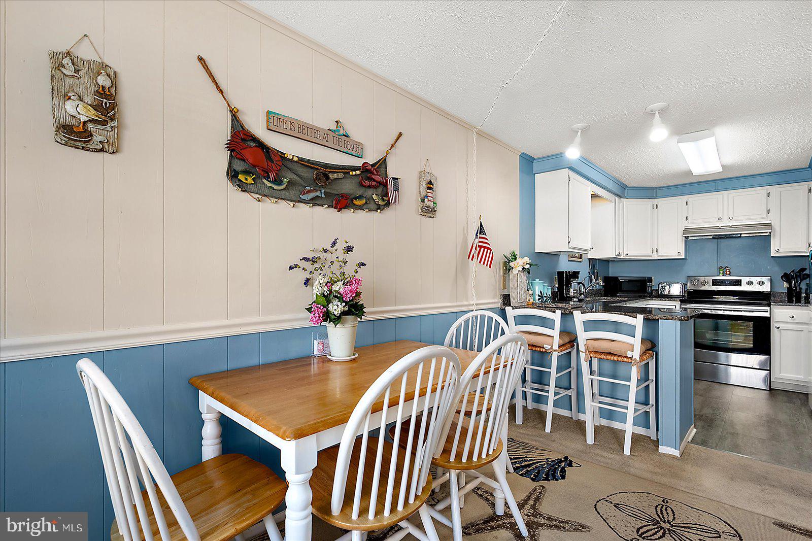 9 46th Street, Unit 22 Ocean City, MD 21842 - Photo 18 of 43 a view of a dining room with furniture and wooden floor