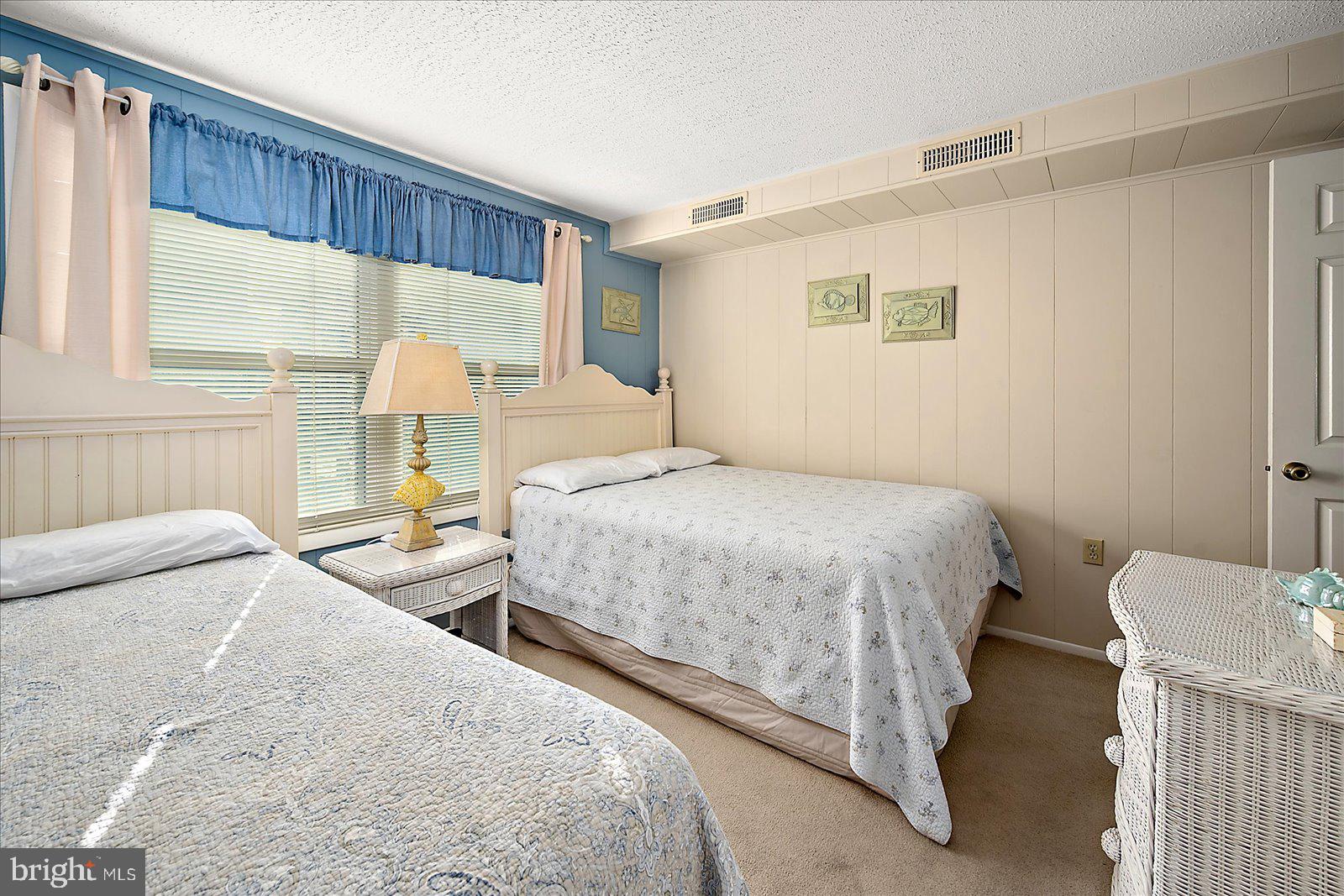 9 46th Street, Unit 22 Ocean City, MD 21842 - Photo 23 of 43 a bedroom with two beds and a large window