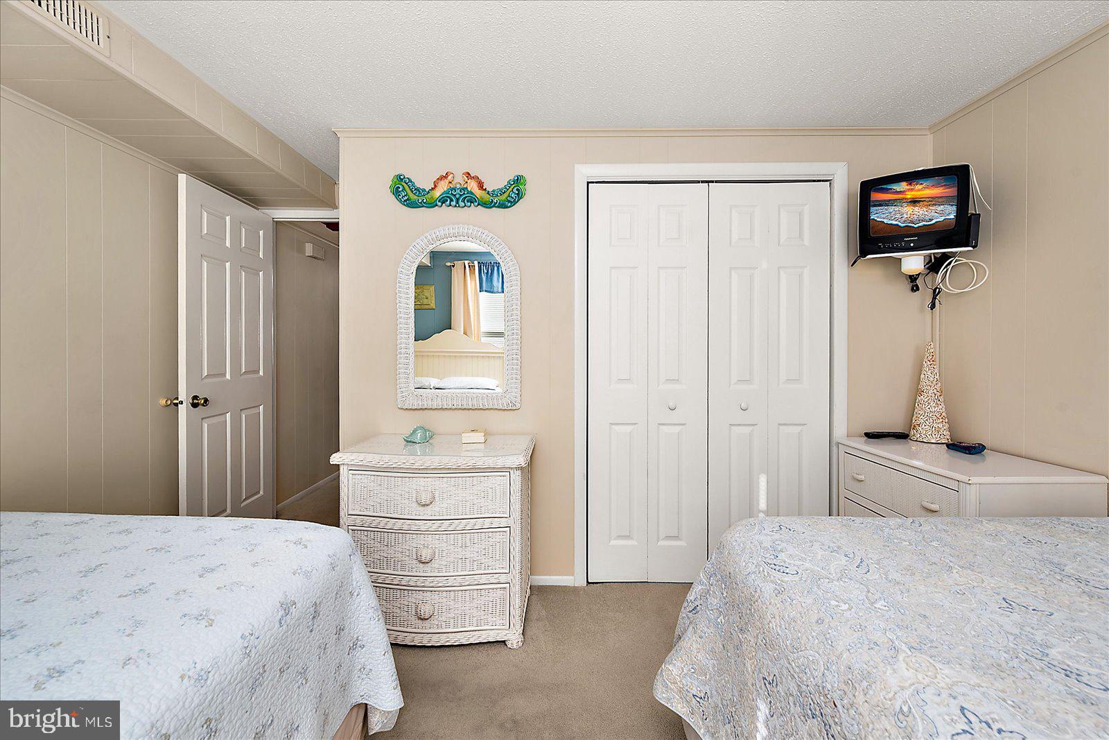 9 46th Street, Unit 22 Ocean City, MD 21842 - Photo 25 of 43 a bedroom with a bed and a tv in it