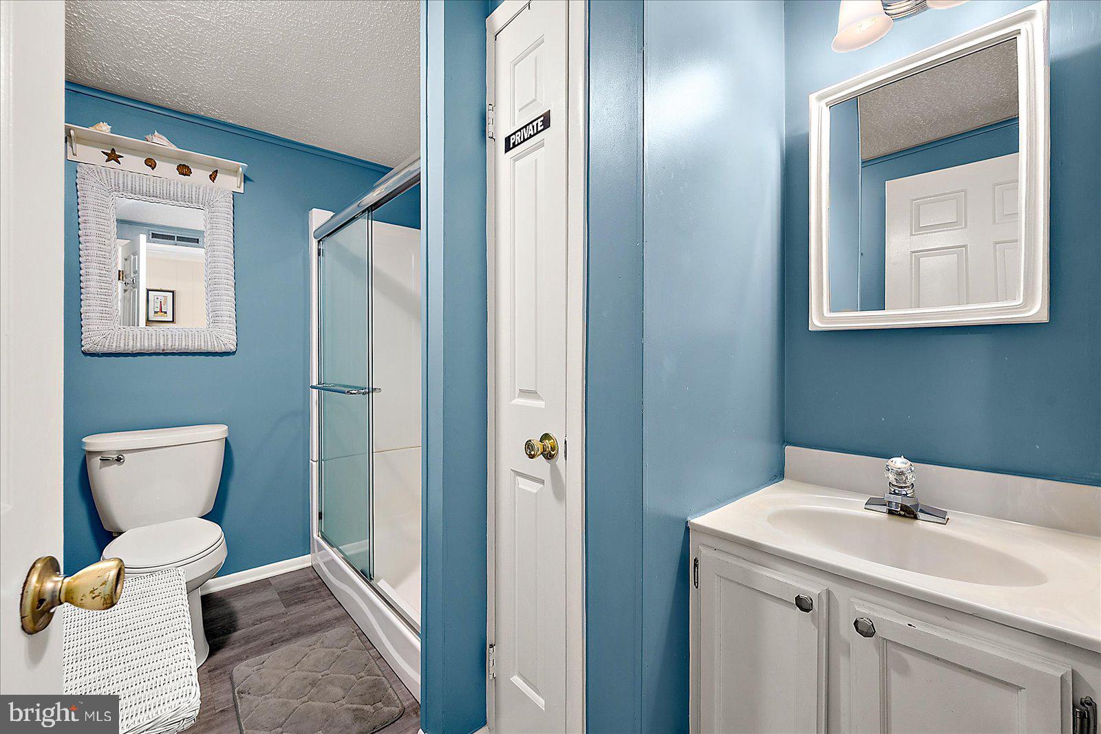 9 46th Street, Unit 22 Ocean City, MD 21842 - Photo 27 of 43 a bathroom with a toilet sink and mirror