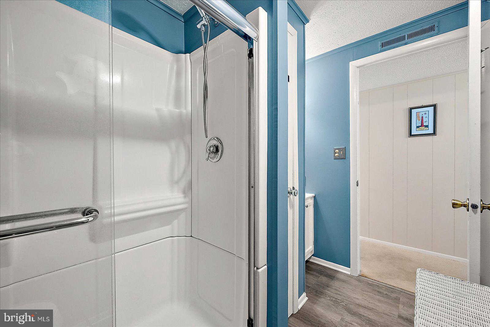 9 46th Street, Unit 22 Ocean City, MD 21842 - Photo 28 of 43 a bathroom with a glass shower door