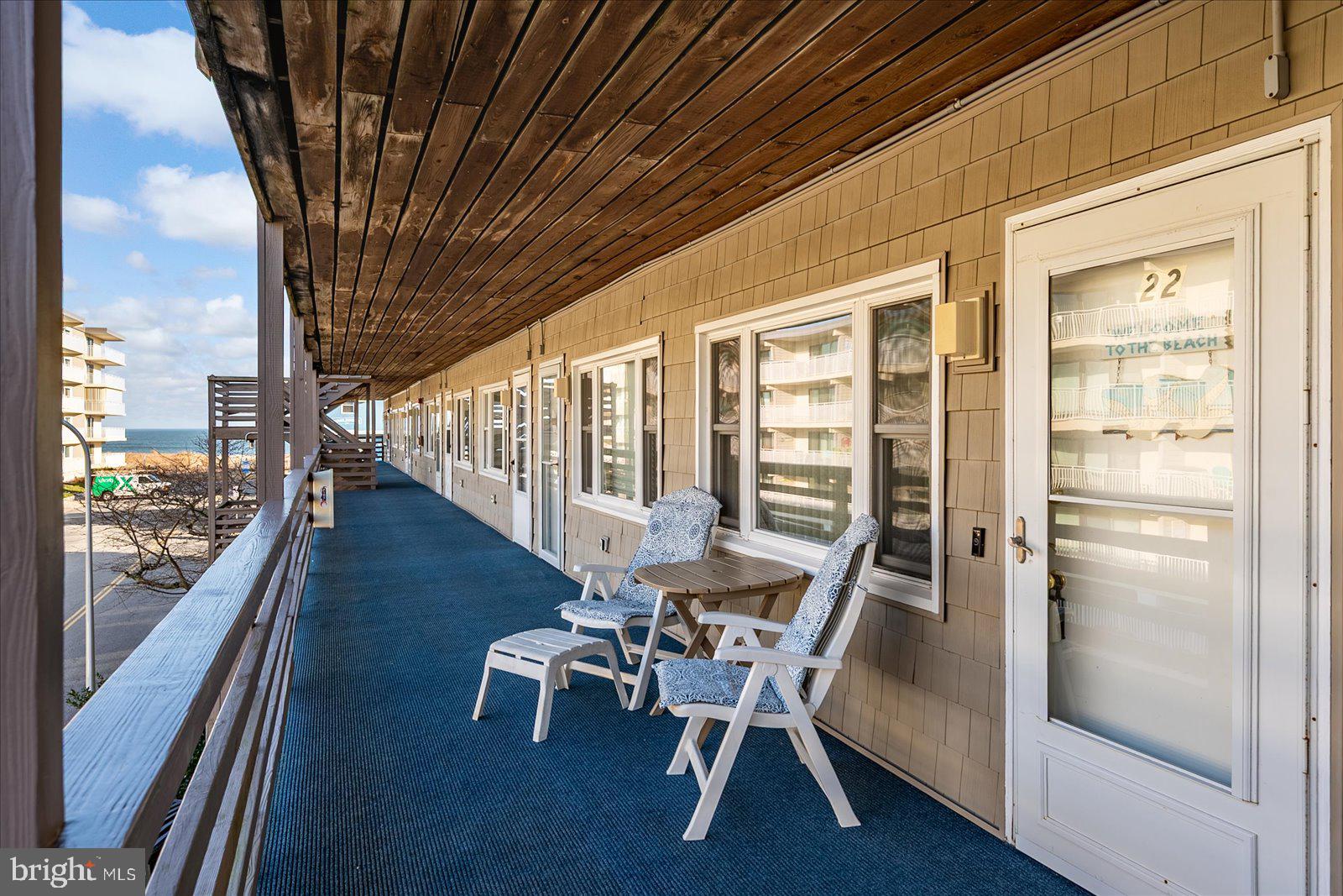 9 46th Street, Unit 22 Ocean City, MD 21842 - Photo 29 of 43 a dining room with furniture wooden floor and a rug