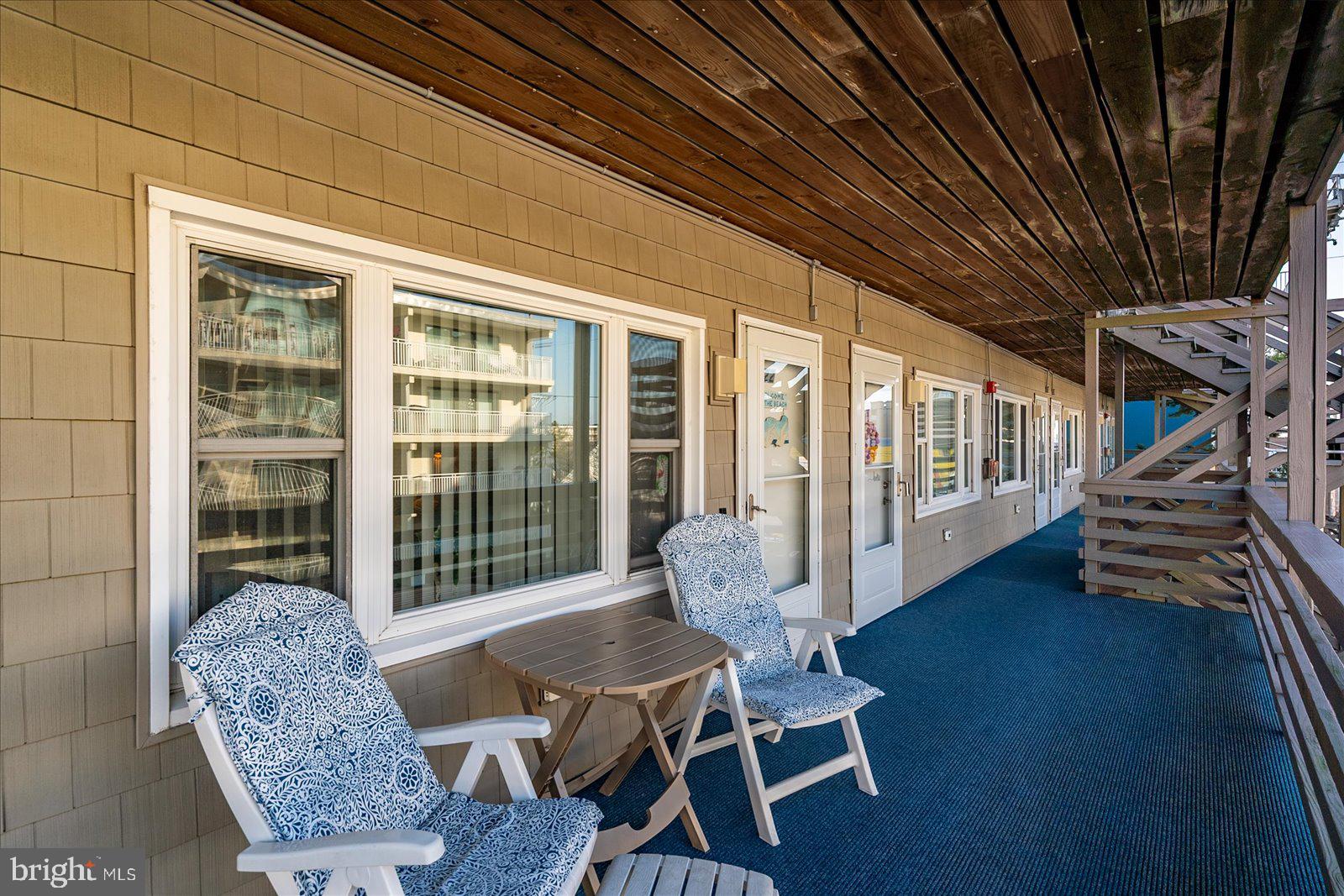 9 46th Street, Unit 22 Ocean City, MD 21842 - Photo 30 of 43 a living room with furniture and a floor to ceiling window