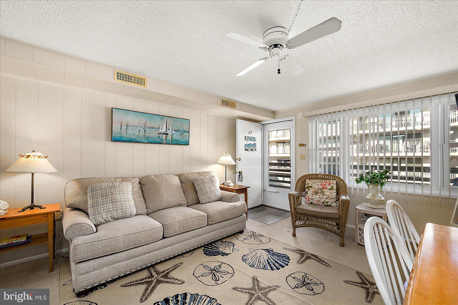 9 46th Street, Unit 22 Ocean City, MD 21842 - Photo 7 of 43 a living room with furniture and a large window with rug