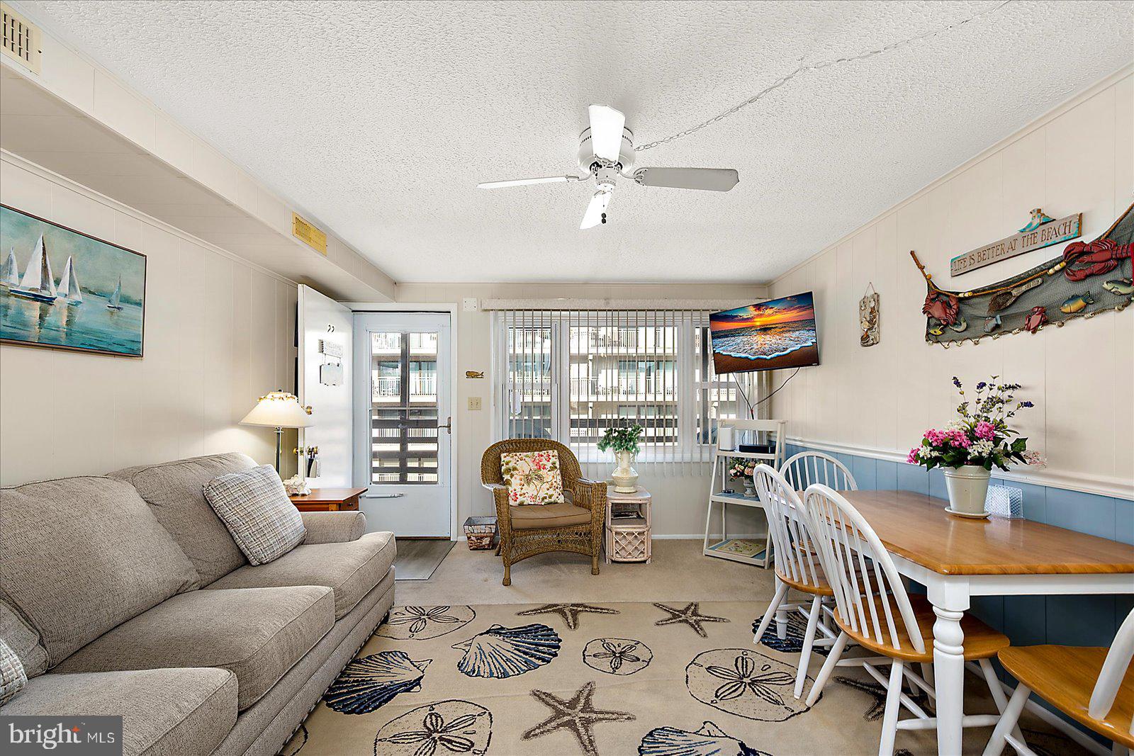 9 46th Street, Unit 22 Ocean City, MD 21842 - Photo 8 of 43 a living room with furniture a chandelier and a rug