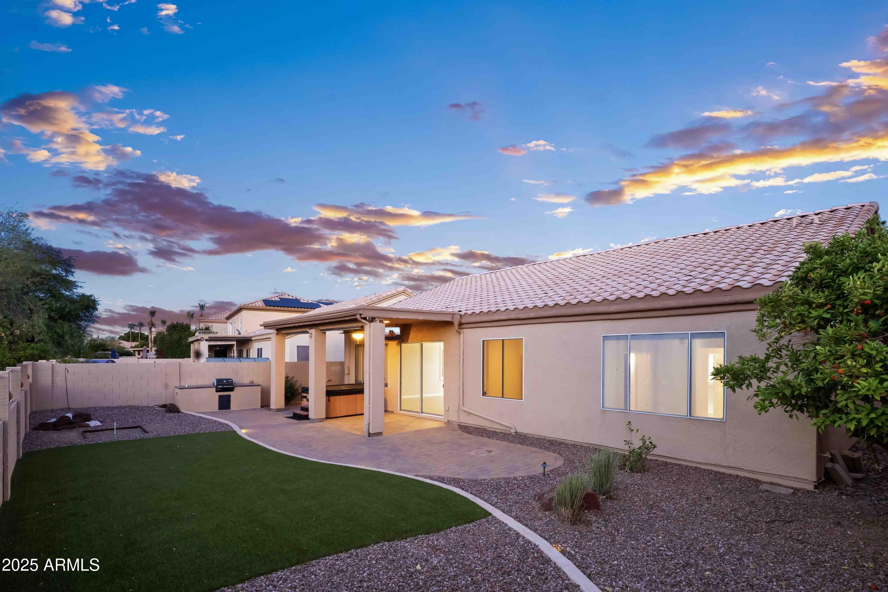 1398 West Windhaven Avenue Gilbert, AZ 85233 - Photo 45 of 58 a front view of a house with a garden and yard