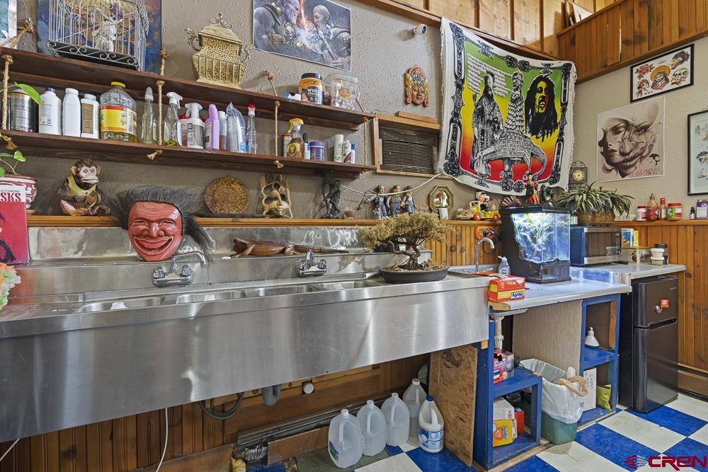 595 East 7th Avenue Durango, CO 81301 - Photo 23 of 34 a kitchen with stainless steel appliances granite countertop a dining table and chairs