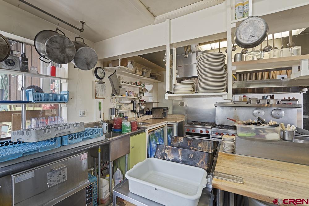 595 East 7th Avenue Durango, CO 81301 - Photo 9 of 34 a kitchen with stainless steel appliances granite countertop a sink and cabinets