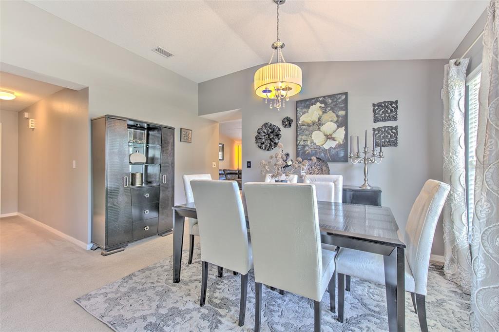 7352 Bridgeview Drive Zephyrhills, FL 33545 - Photo 13 of 49 a view of a dining room and a table and chairs