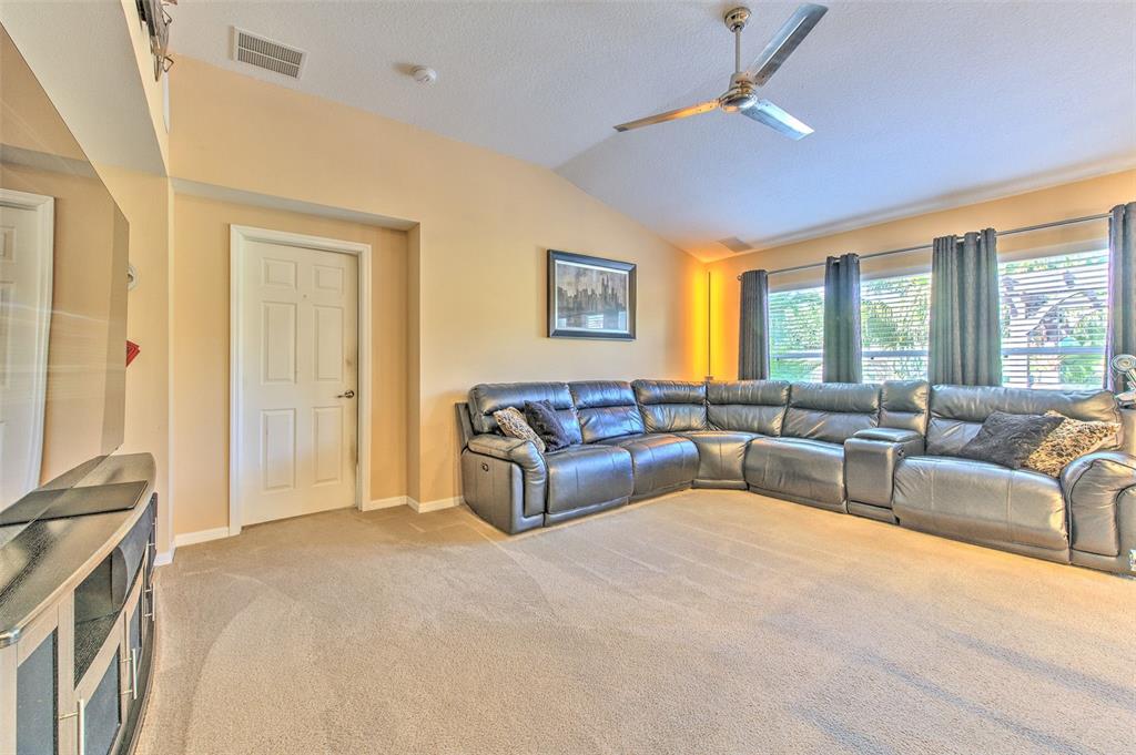 7352 Bridgeview Drive Zephyrhills, FL 33545 - Photo 23 of 49 a living room with furniture and a large window