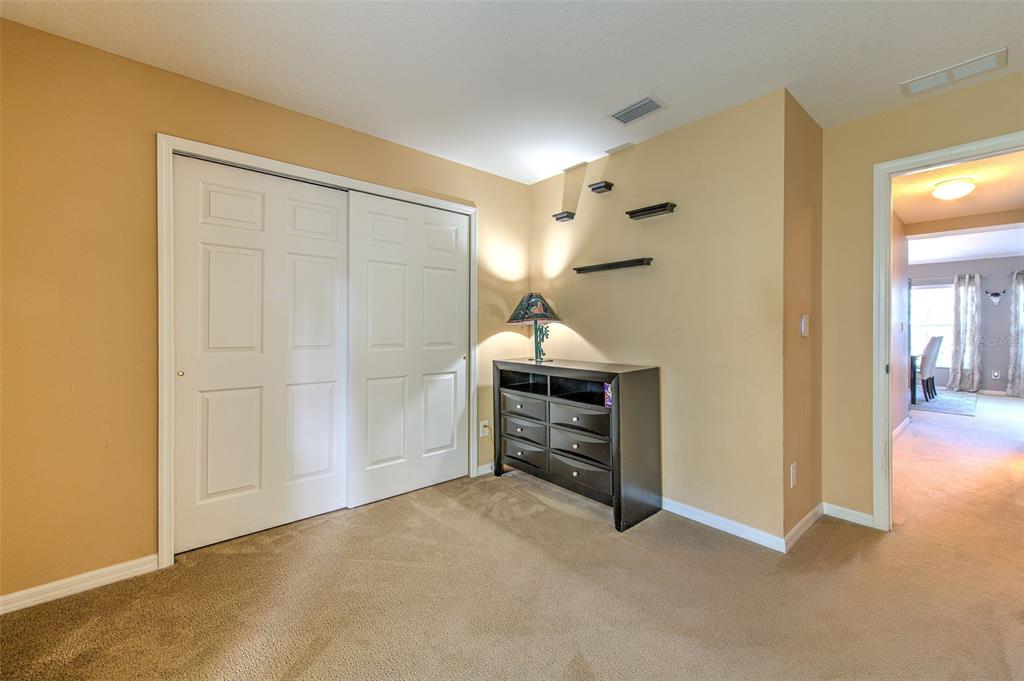 7352 Bridgeview Drive Zephyrhills, FL 33545 - Photo 25 of 49 a view of empty room with furniture and wooden floor