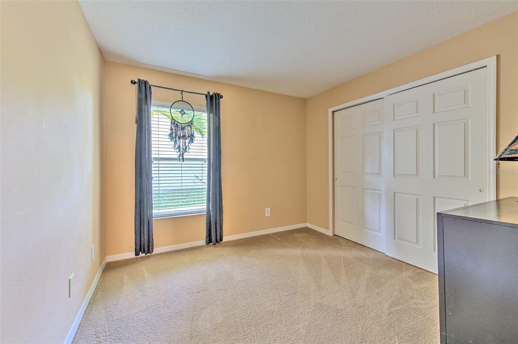 7352 Bridgeview Drive Zephyrhills, FL 33545 - Photo 26 of 49 an empty room with windows