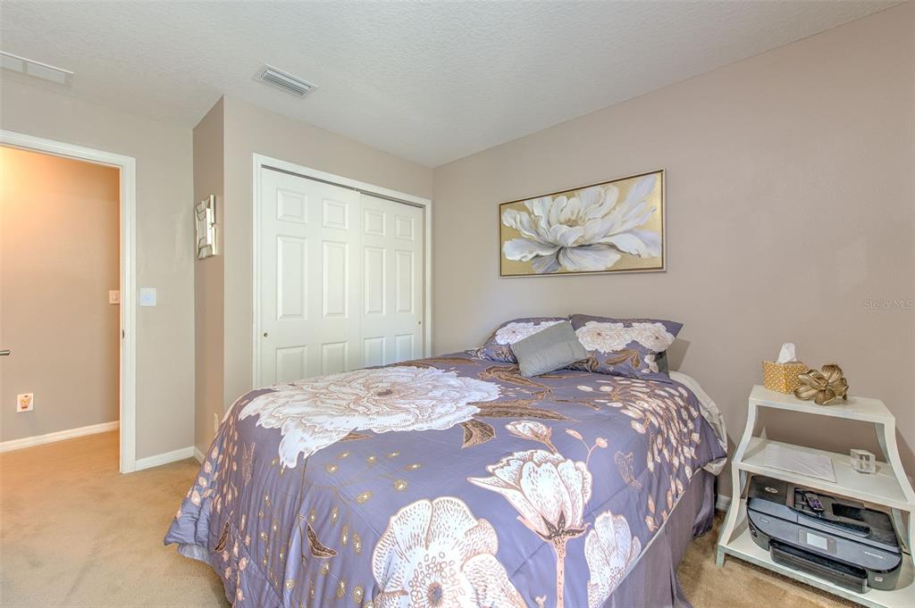 7352 Bridgeview Drive Zephyrhills, FL 33545 - Photo 27 of 49 a bedroom with a bed and a painting on the wall