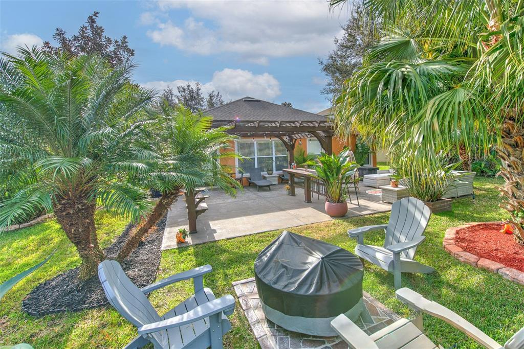 7352 Bridgeview Drive Zephyrhills, FL 33545 - Photo 33 of 49 a view of an chairs and table in the patio