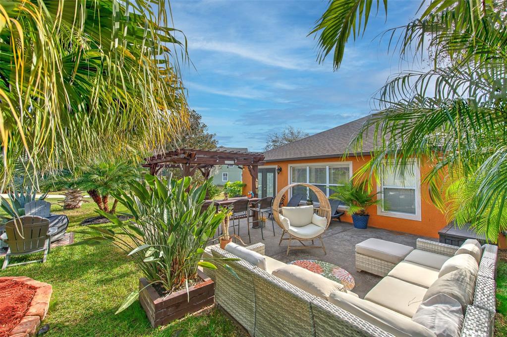 7352 Bridgeview Drive Zephyrhills, FL 33545 - Photo 35 of 49 a view of a backyard with couches chair and potted plants