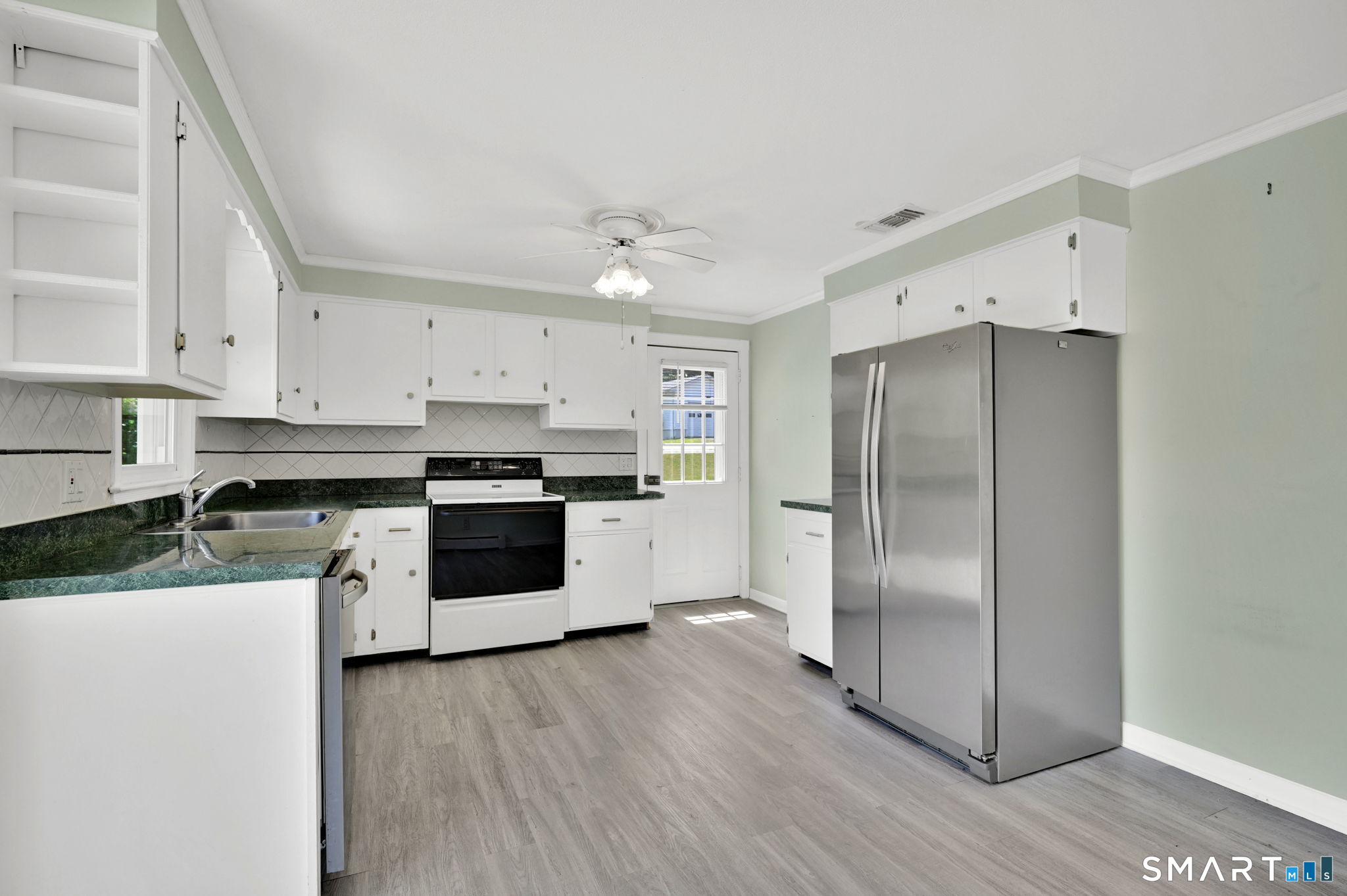 7 Rogers Drive Meriden, CT 06450 - Photo 14 of 40 a kitchen with stainless steel appliances a refrigerator sink and white cabinets