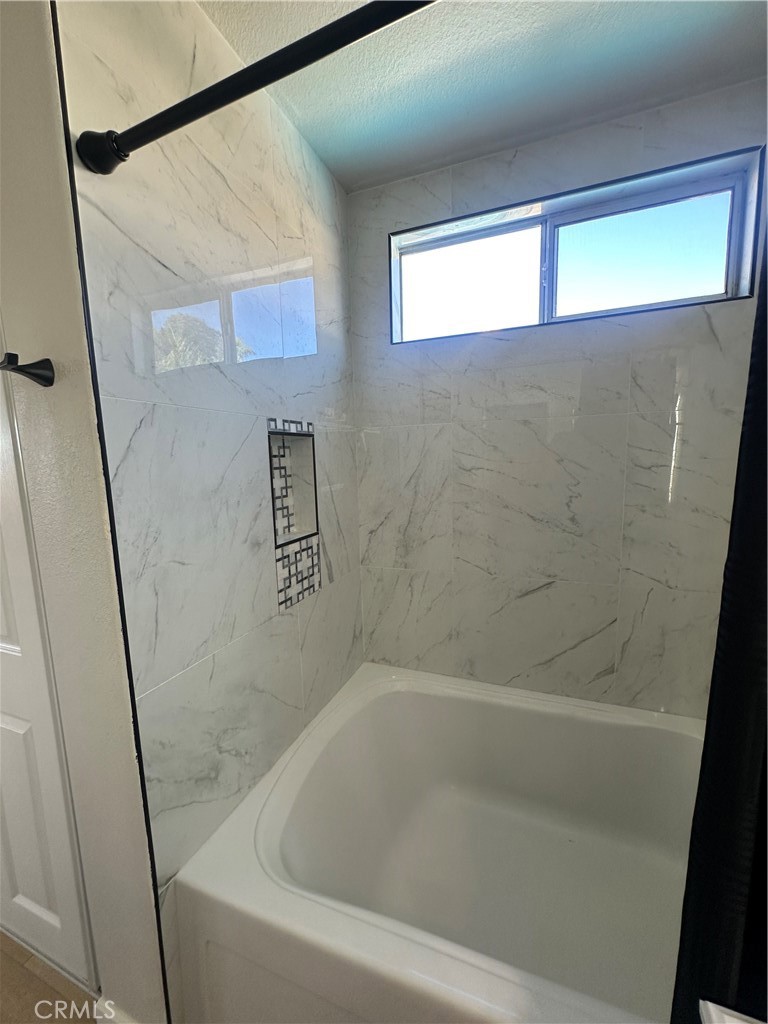 29652 Chandler Road Highland, CA 92346 - Photo 14 of 22 a bathroom with a bathtub