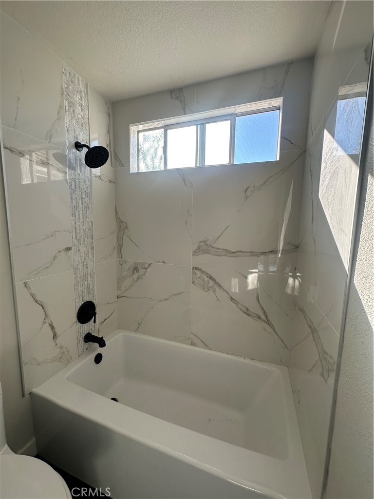 29652 Chandler Road Highland, CA 92346 - Photo 18 of 22 a bathroom with a bathtub and a window