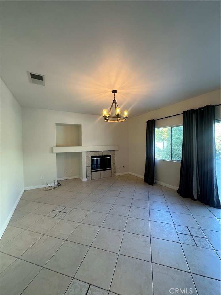 29652 Chandler Road Highland, CA 92346 - Photo 6 of 22 an empty room with windows and fireplace