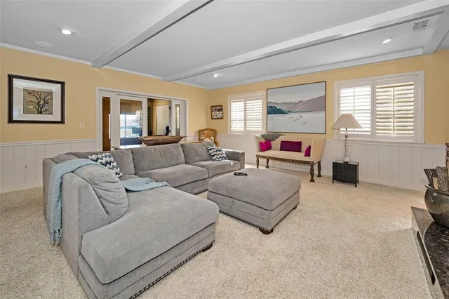 a bedroom with a bed lamps dresser and a window