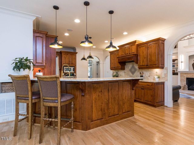 a kitchen with a table and chairs in it
