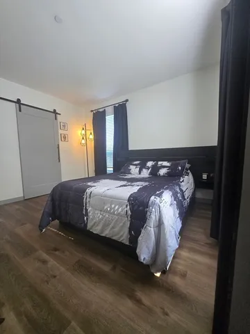 a bedroom with a bed and window