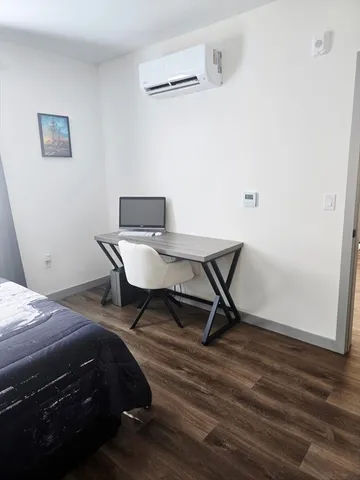 a bedroom that has a bed and a chair in it