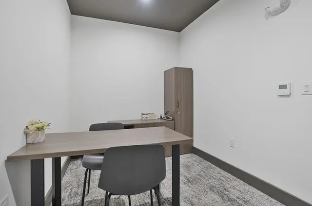 a view of a workspace with furniture