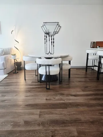 a view of a dining room with furniture and wooden floor