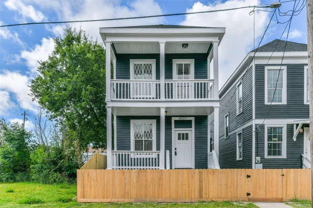 a view of a hallway with wooden floor and entryway