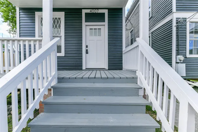 a kitchen with stainless steel appliances granite countertop a refrigerator a sink dishwasher a oven with white cabinets and wooden floor