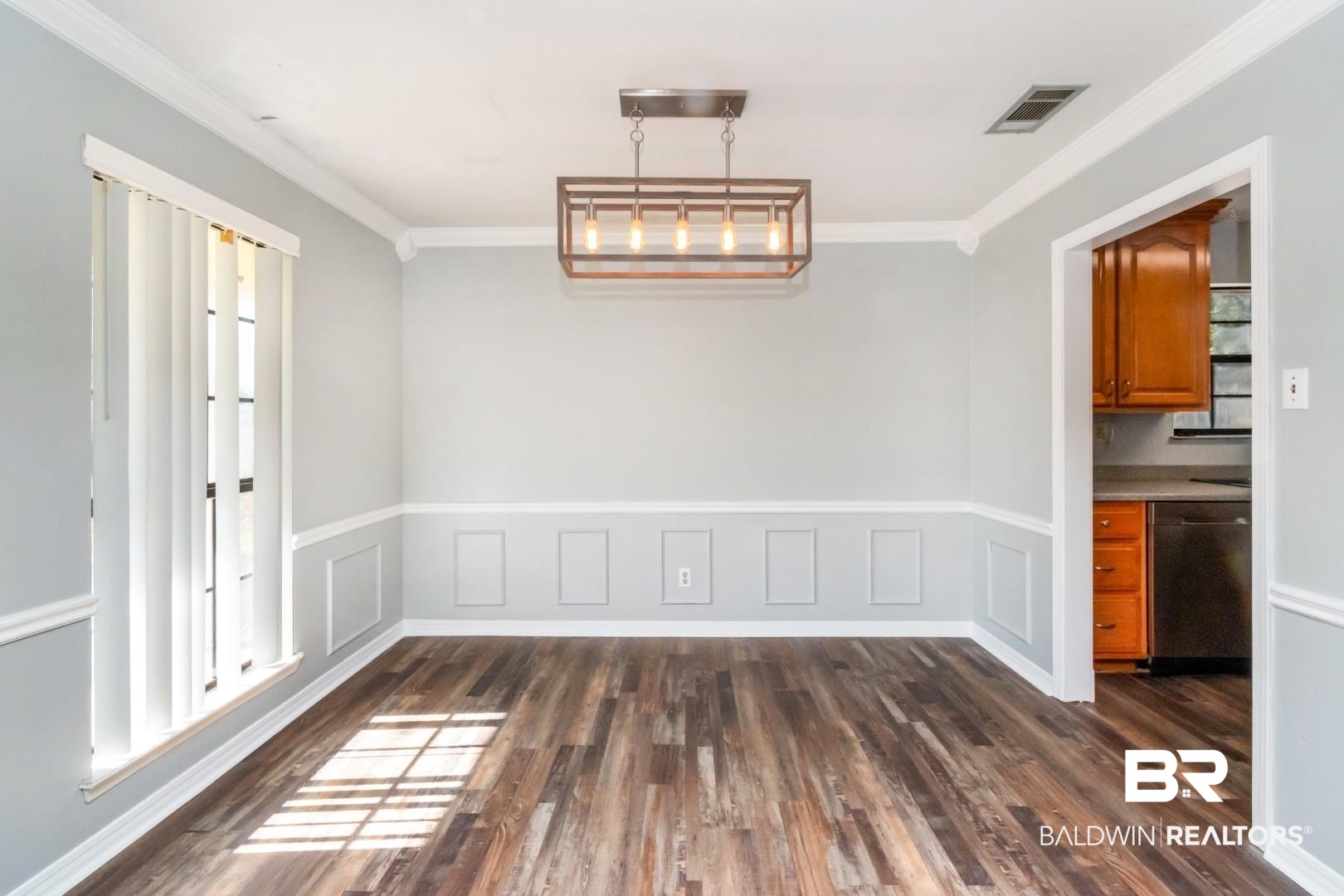 8304 Champlain Circle Mobile, AL 36695 - Photo 10 of 46 Unfurnished dining area featuring dark hardwood / wood-style flooring and ornamental molding