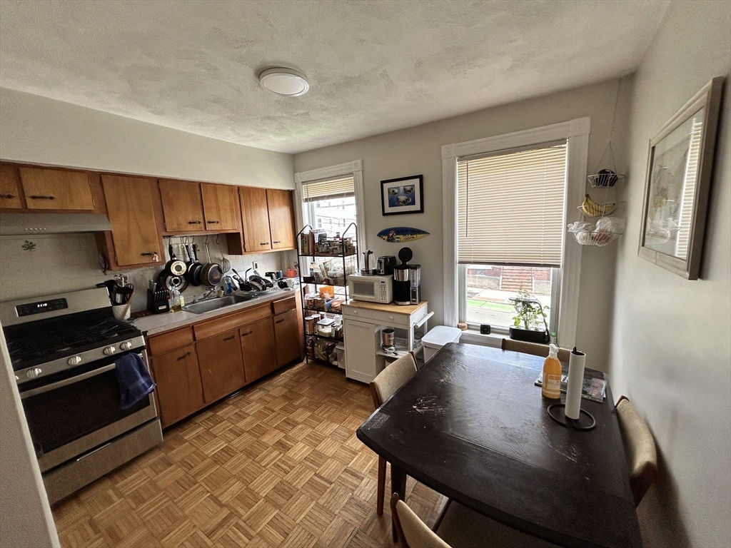 328 Beacon Street, Unit 2F Somerville, MA 02143 - Photo 2 of 6 a kitchen with a refrigerator and a stove top oven