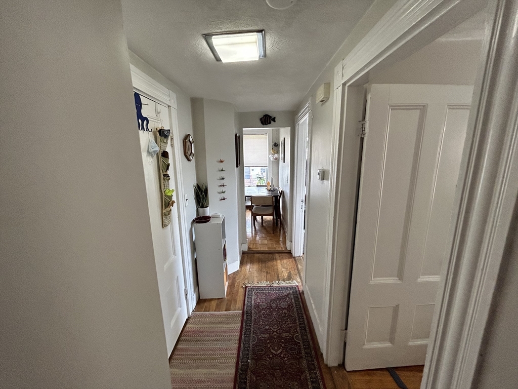 328 Beacon Street, Unit 2F Somerville, MA 02143 - Photo 4 of 6 a view of a hallway with wooden floor and entryway