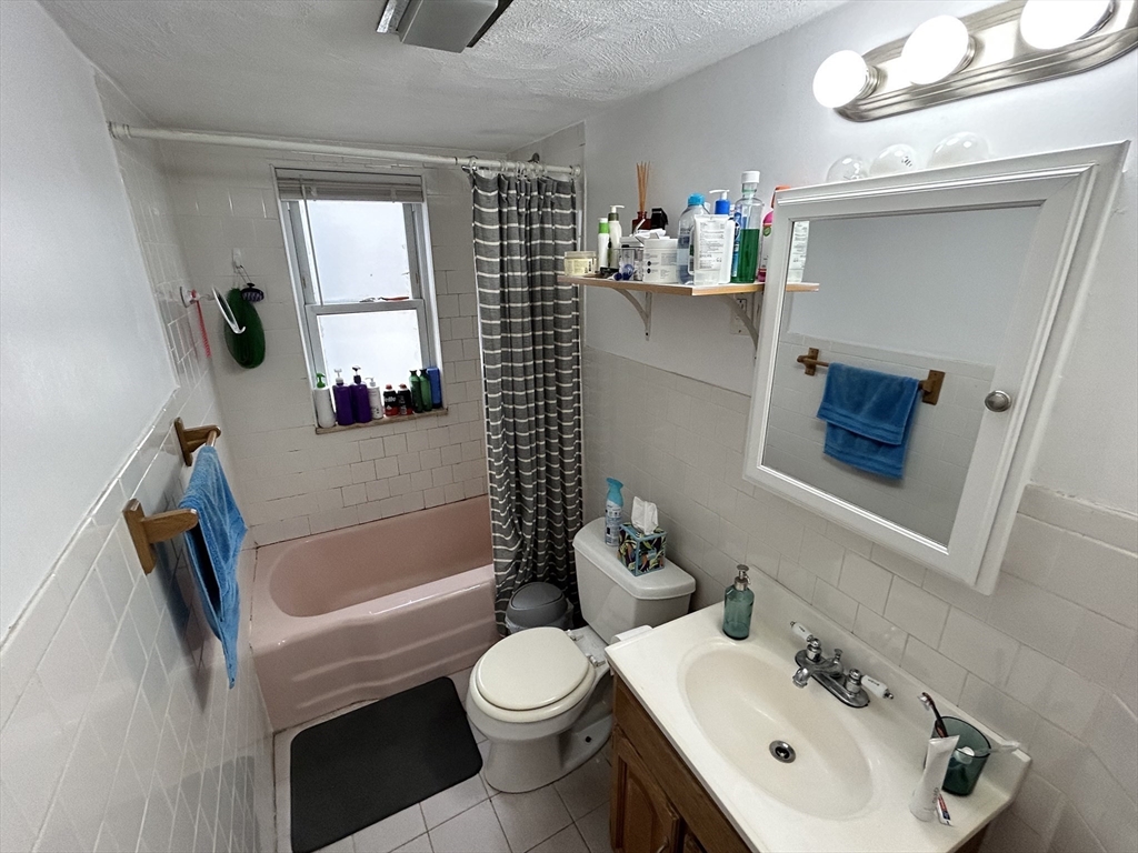 328 Beacon Street, Unit 2F Somerville, MA 02143 - Photo 6 of 6 a bathroom with a sink toilet and shower