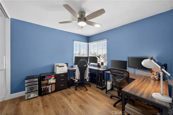 a view of a workspace with furniture and a window
