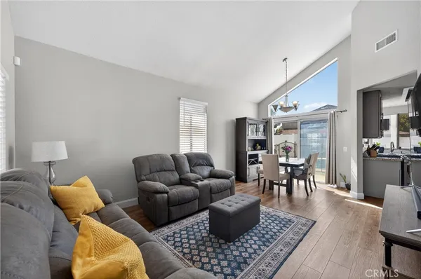 a living room with furniture a rug and a table