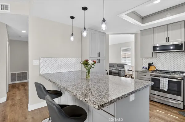 a kitchen with kitchen island granite countertop a table and chairs