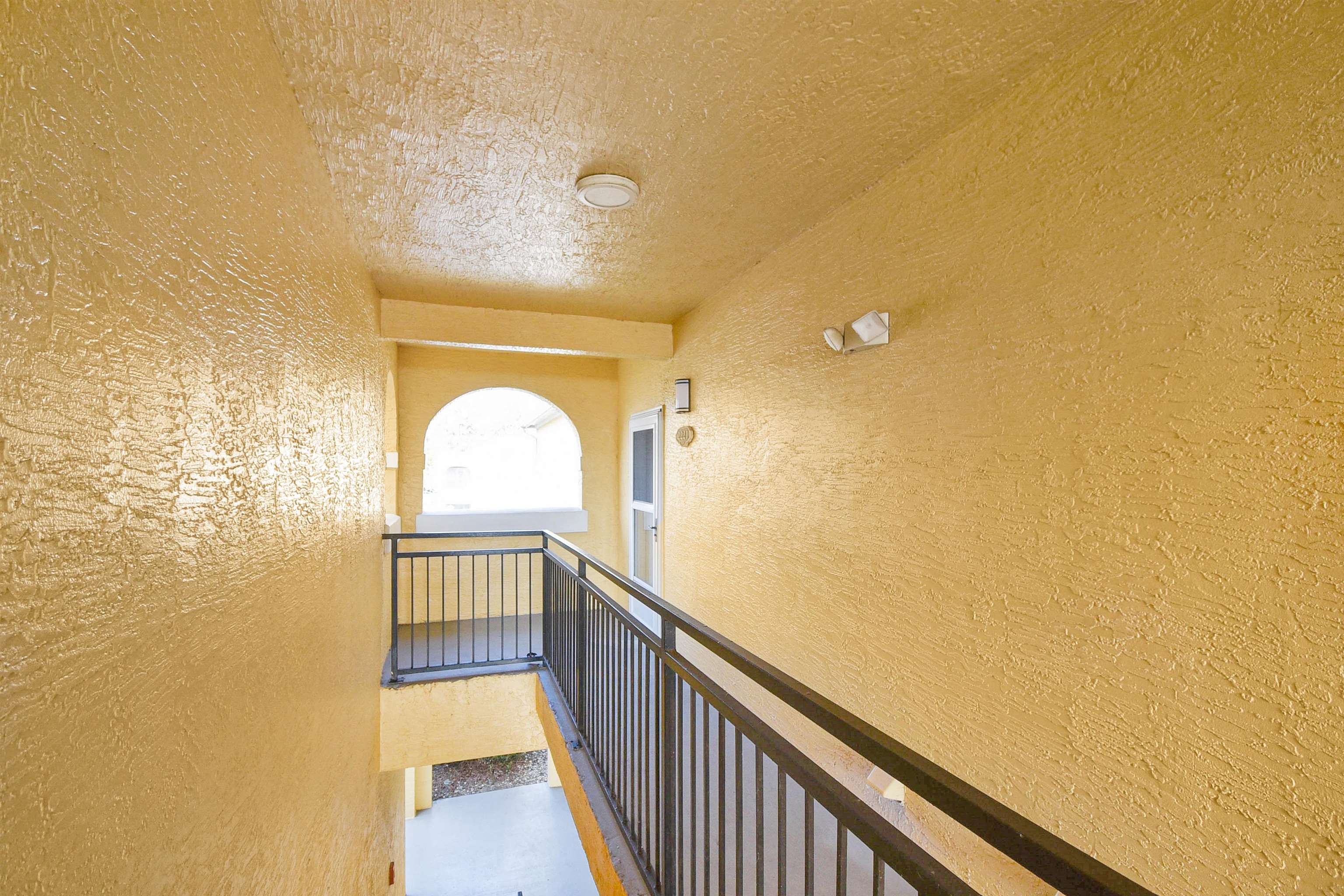 2221 Vista Cove Road St. Augustine, FL 32084 - Photo 4 of 30 a view of a hallway with wooden floor and a floor to ceiling window
