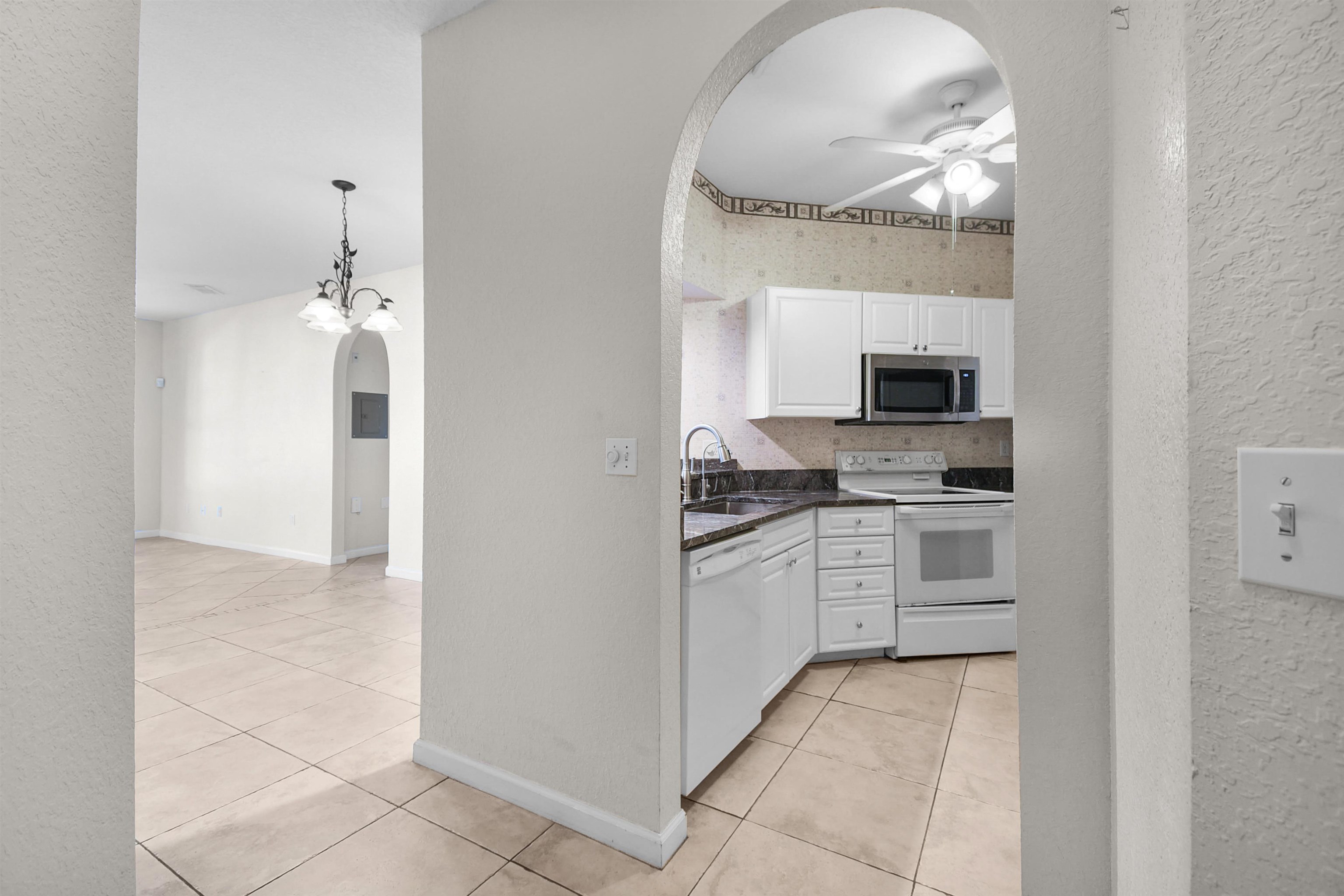 2221 Vista Cove Road St. Augustine, FL 32084 - Photo 5 of 30 a kitchen with white cabinets and appliances