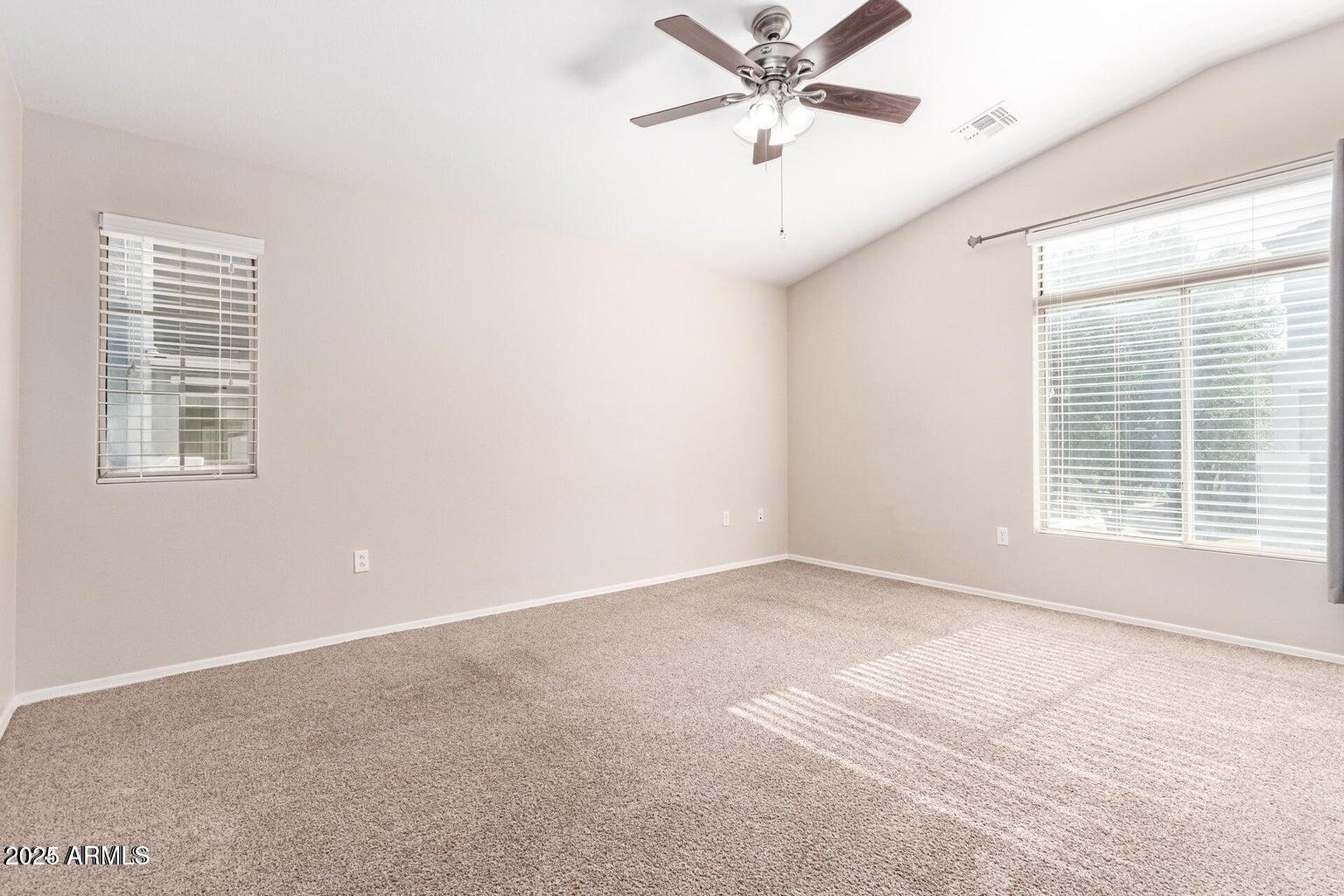 2402 East 5th Street, Unit 1402 Tempe, AZ 85288 - Photo 16 of 36 an empty room with a window and a fan