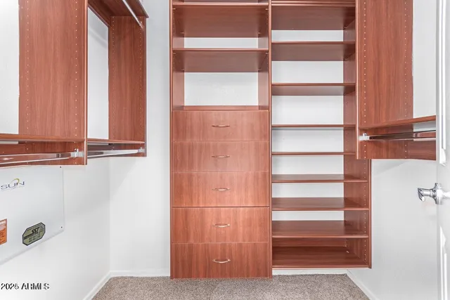 a view of walk in closet with empty racks